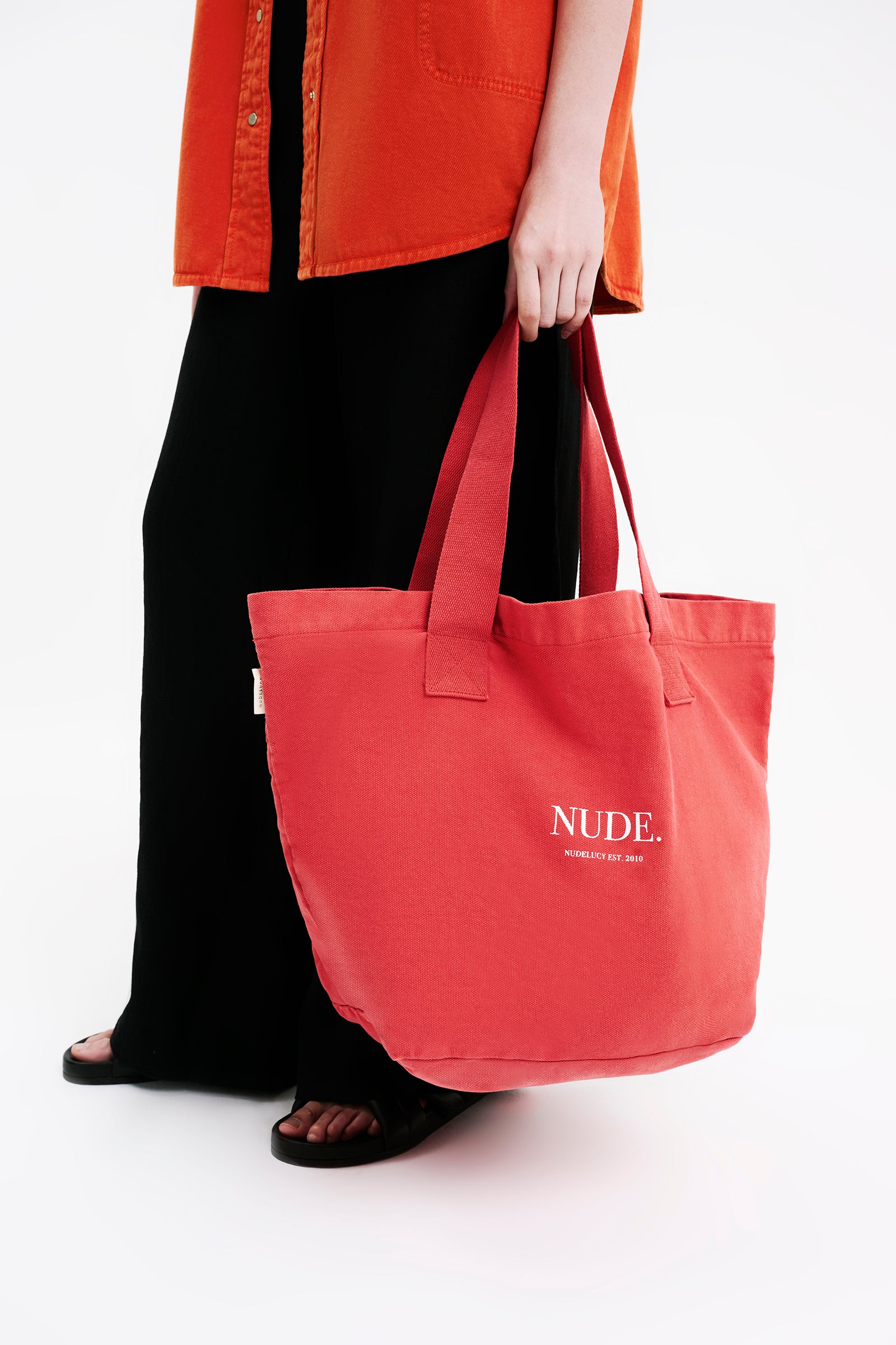 Nude Lucy Nude Tote Bag in a Pink & Orange Toned Coral Colour